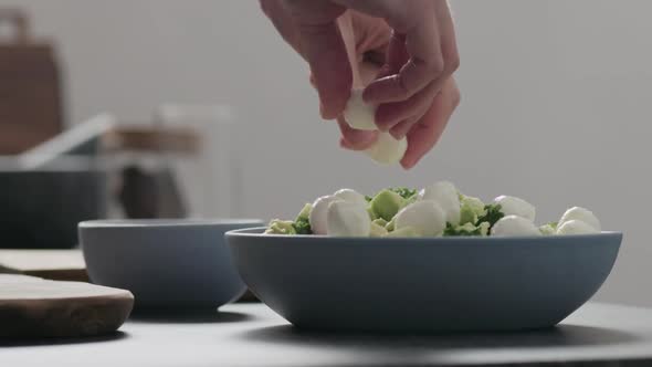 Slow Motion Man Make Salad with Kale Mozzarella Avocado and Cherry Tomatoes Add Mozzarella