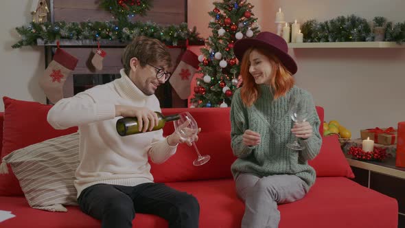 Hansome man and red hair woman wearing winter sweaters celebrating New Year