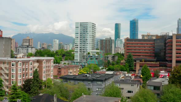 Drone Ascend Over City Street With Panorama Of Modern High-rise Buildings At West End, Vancouver, Ca