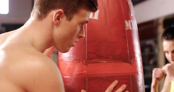 Female boxer practicing with trainer