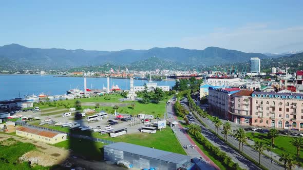 Drone view of the sea, mountains, ships, road with cars, embankment in Batumi, Georgia