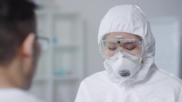 Doctor in Hazmat Suit Examining Contagious Patient alt