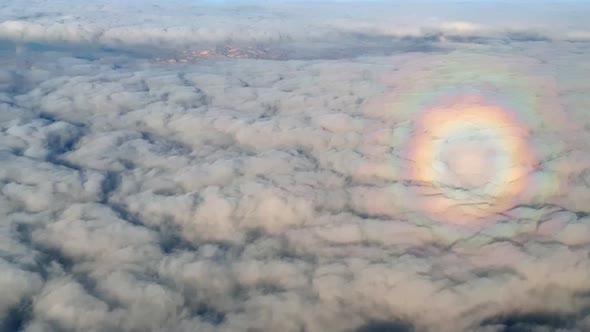 Aerial shot of rare and unique circle halo rainbow effect over the clouds