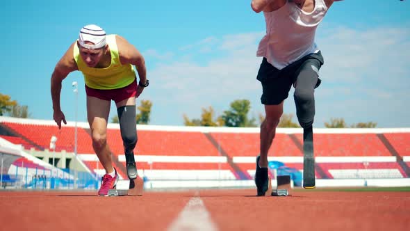 Running Start Held By Two Male Paralympians