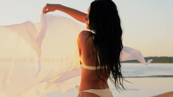 Woman in Bikini Swimsuit with Pareo on Beach