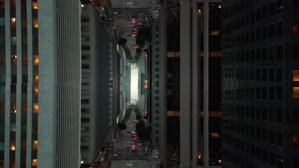 Forward Flying Above Street Among Modern Tall Buildings