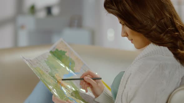 Pretty Lady Planning Trip for Weekend, Vacation, Studying Map