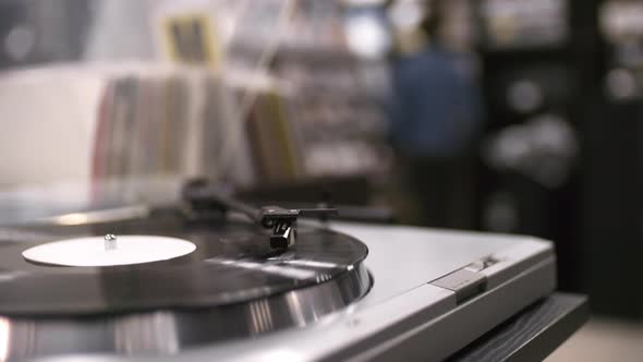 Vinyl Record Spinning on Turntable in Music Store