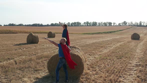 Aerial Shot of Dad with Son in Superhero Costumes