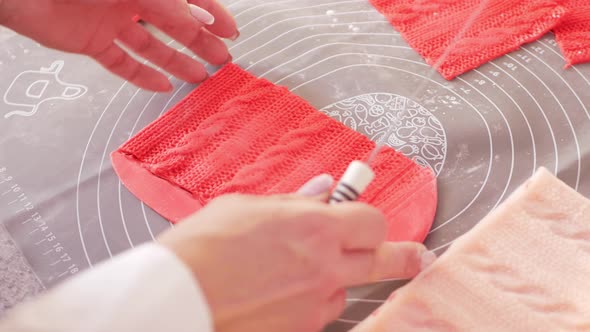 Confectioner Decorates Cake with Red Mastic in Form of Knitted Pattern