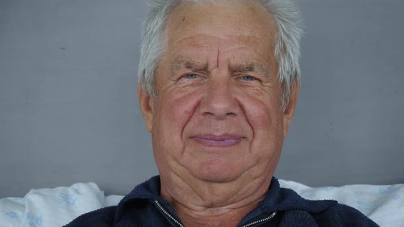 Portrait Of Old Caucasian Man With Gray Hair And Deep Wrinkles Looking At Camera