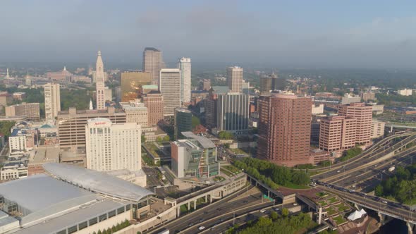 Aerial of busy street and high-rise buildings along river coast Hartford