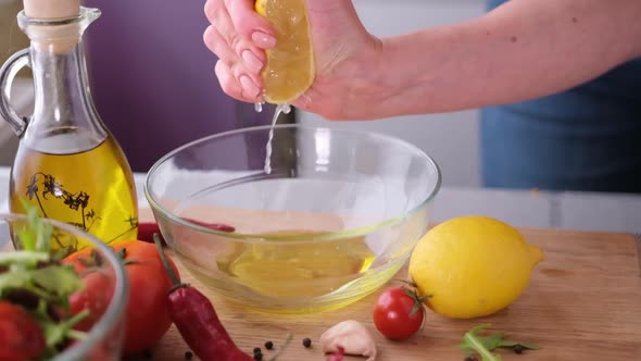Making Salad Sauce  Squeezing Fresh Lemon Juice Into Glass Bowl