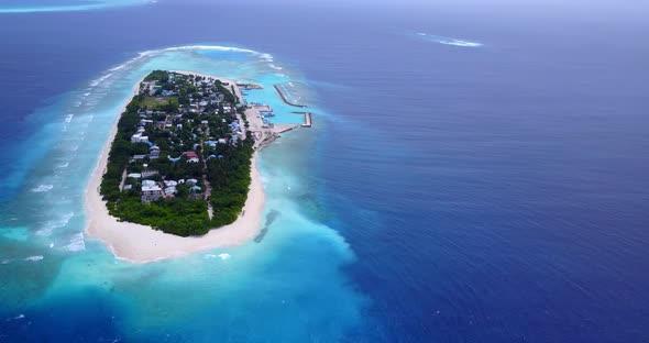 Wide flying island view of a white paradise beach and blue water background in colorful 