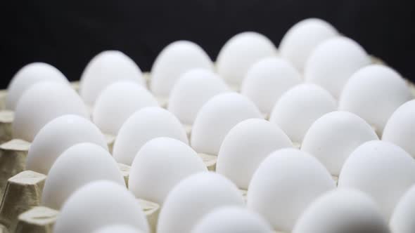 White chicken eggs in a cardboard box. Eggs in a paper tray.