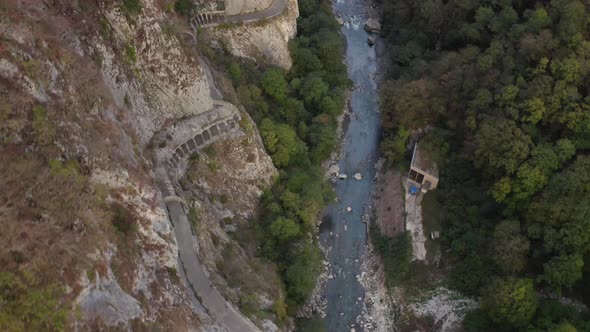 Aerial View Top Shot Beautiful Mountain River Mzymta Stream Flow Surrounded By High Natural Cliff