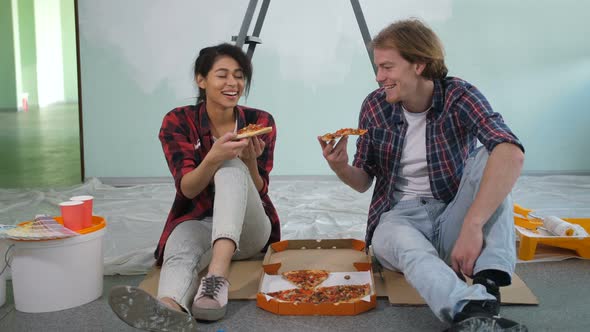 Happy Couple Eating Pizza While Making Renovation