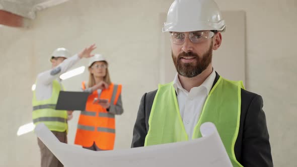 Portrait of Engineer Wearing Protective Helmet Standing on Construction Side
