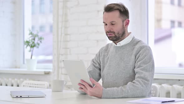 Creative Man Using Tablet in Office