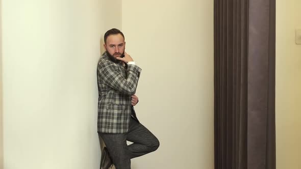 Stylish Young Man In Clothing Store Posing In New Suit.