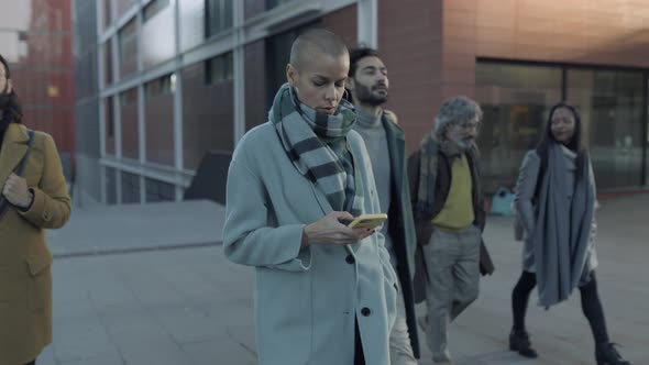 Successful Business Woman Messaging on Mobile Phone in City Street