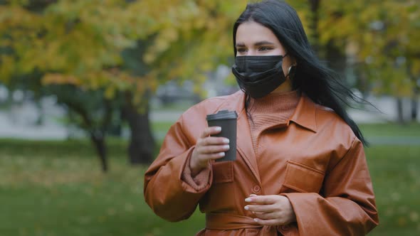 Closeup Young Woman Stands in Autumn Park Beautiful Hispanic Girl Holding Disposable Cup of Coffee