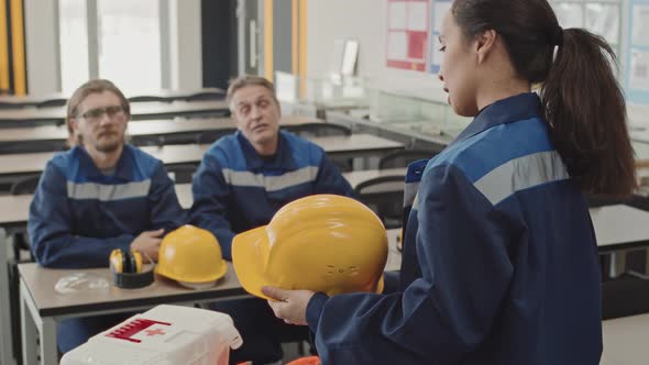 Supervisor Explaining Necessity Of Hard Hats Usage At Workstation