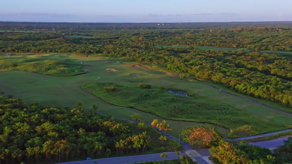 Flying over golf course of Playa Nueva Romana in Dominican Republic. Aerial pov