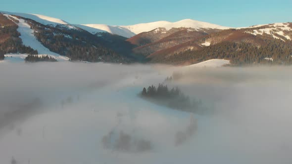 Flying Over Clouds in the Winter Morning Sunrise in Carpathian Mountains