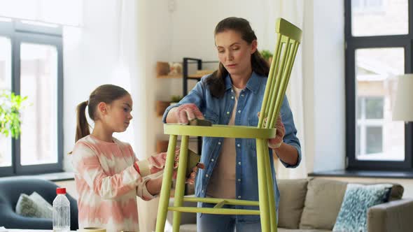 Mother and Daughter Sanding Old Chair with Sponge