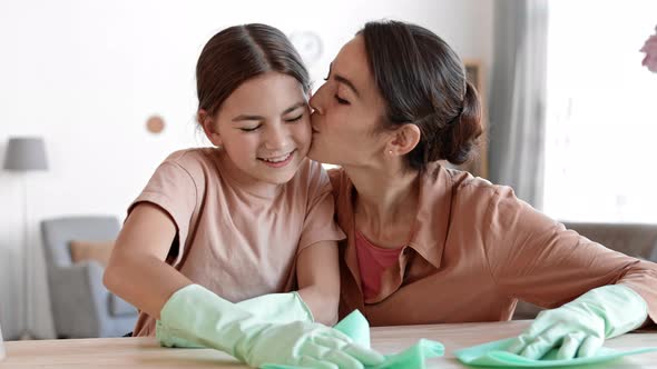 Mom and Daughter Dusting off Desktop at Home