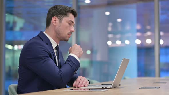 Businessman Thinking and Working on Laptop in Office