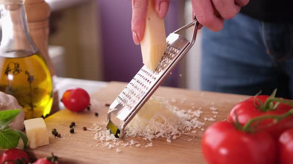 Making Pasta Carbonara  Grating Parmesan Cheese on Wooden Cutting Board