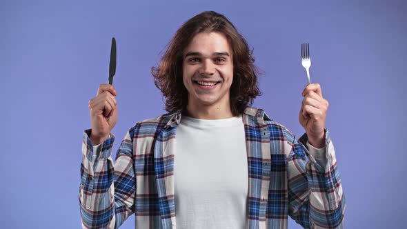 Portrait of Hungry Man with Fork and Knife