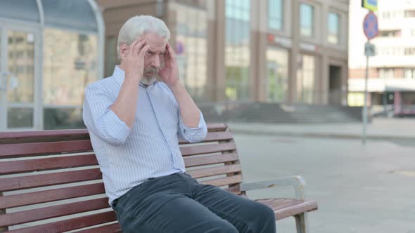 Old Man with Headache Sitting Outdoor on Bench