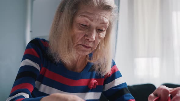 Elderly Person Putting Money Into Her Wallet