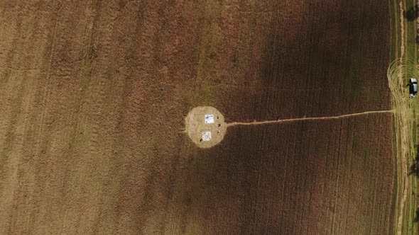 Top View of a Circle on a Wheat Field and a Group of Young People Participating in a Performance