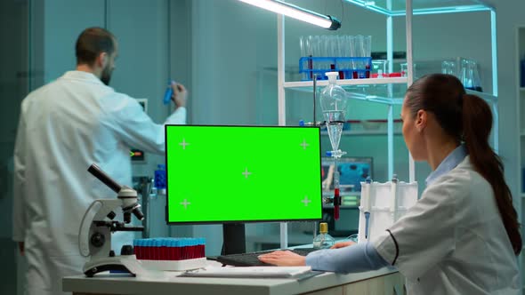 Biochemist Developing Drugs Working on Computer with Green Screen