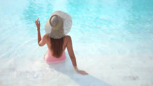 Young asian woman enjoy around outdoor swimming pool for leisure