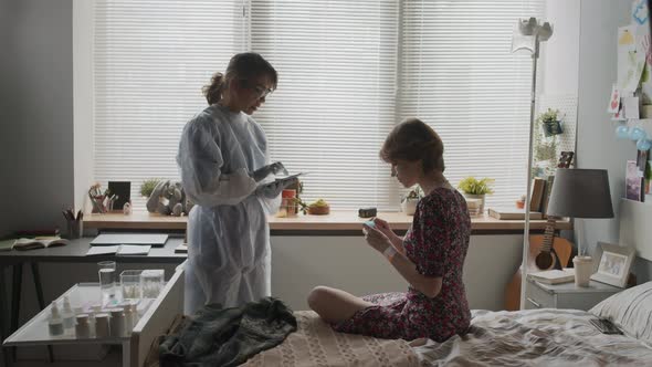 Doctor Giving Pill and Water to Girl