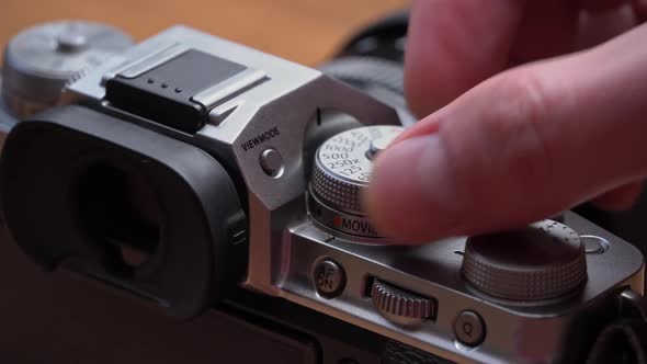 Man's Hands Turn the Aperture Wheel on a Vintage Camera Closeup