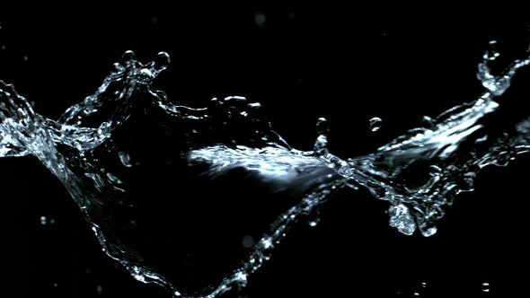 Super Slow Motion Shot of Swirling and Splashing Water Isolated on Black Background at 1000Fps