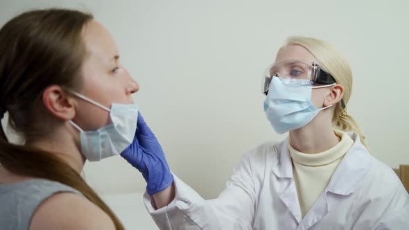 The Nurse Takes a Sample From the Patient's Nose Using a Special Stick