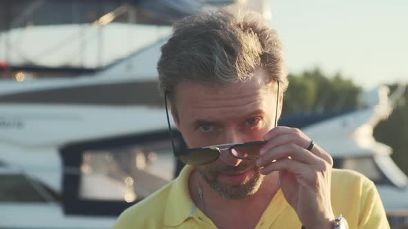 Handsome Successful Man on the Yacht Talking on Mobile Phone. Portrait of Business Man on Sailing