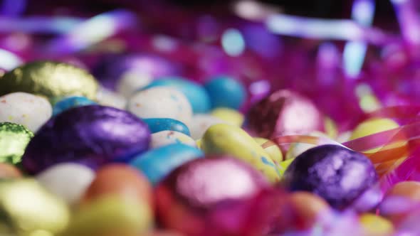 Rotating shot of colorful Easter candies on a bed of easter grass 