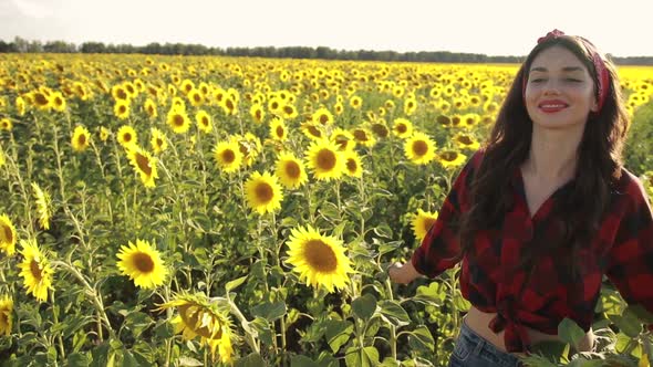 Sensual Brunette Girl Walking in Sunflower Field