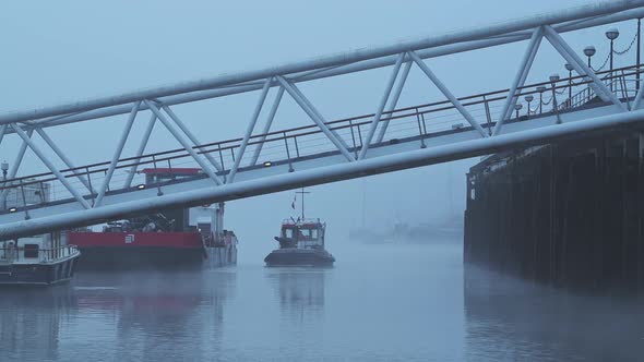 Boat on the River Thames in Central London on a cool blue misty morning on day one of Coronavirus Co