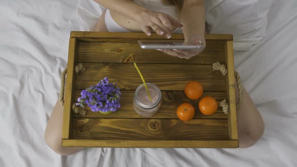 Top View of Woman with Touchpad and Smoothie