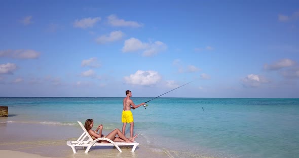 Young Couple Married on Vacation Enjoy Luxury on Beach on Clean White Sand