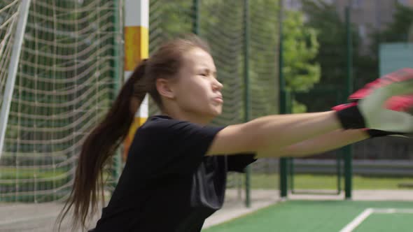 Young Female Goalkeeper defending the Goal during Soccer Training